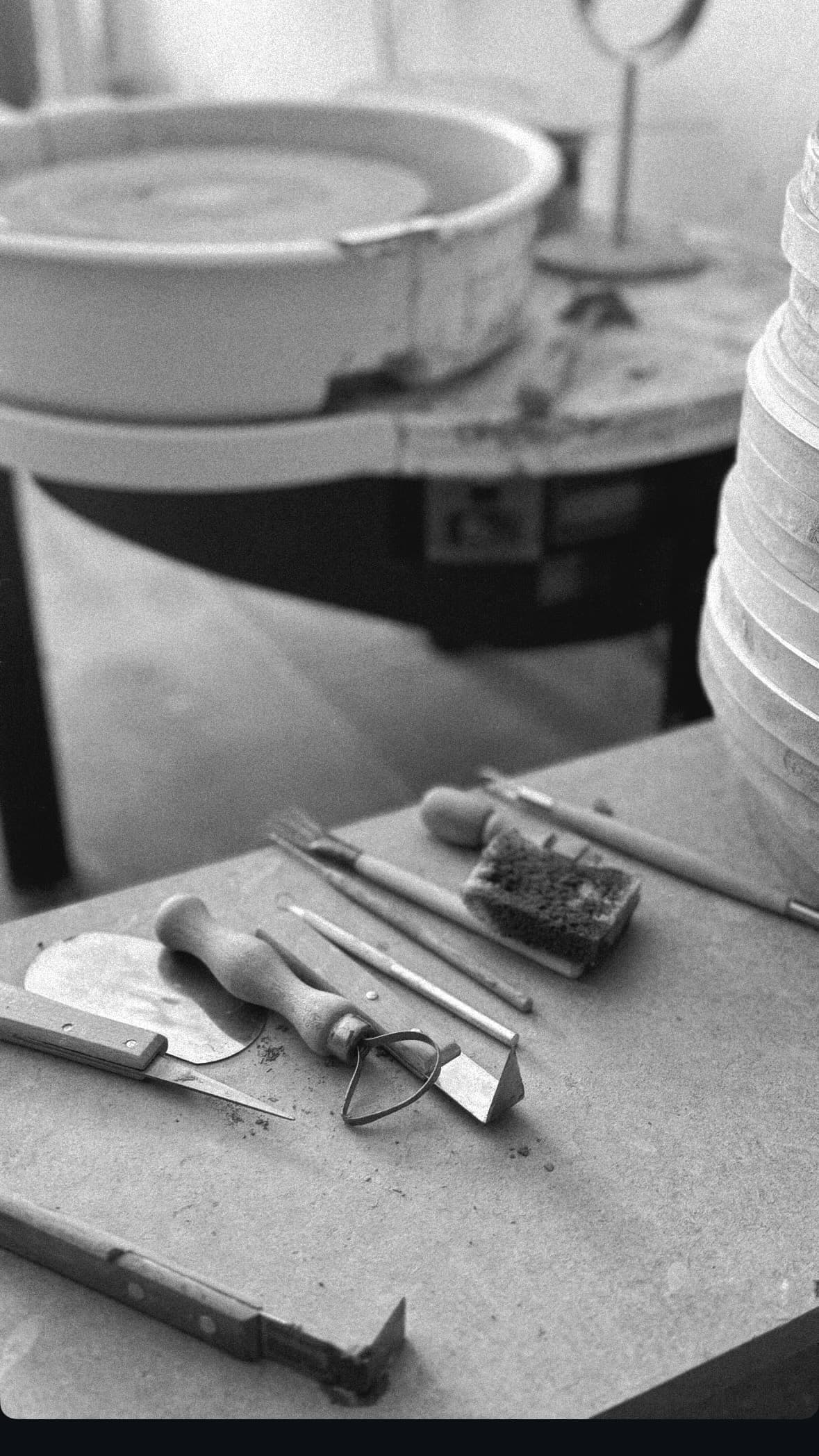 Hands shaping clay on a pottery wheel
